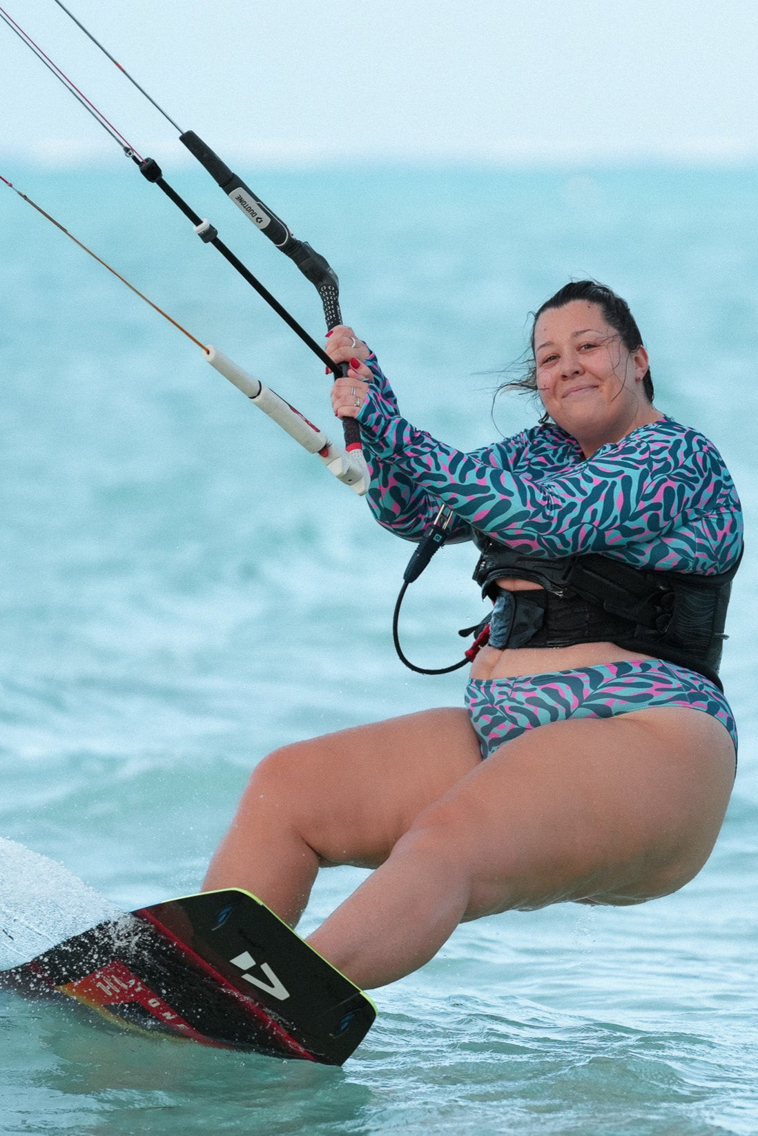 cropped top rash guard for practicing water sports, like surfing or kiting, as well as enjoying life at the beach with a s print with blue, turquoise and pink with finger holes - part of a set with bikini - plus size 