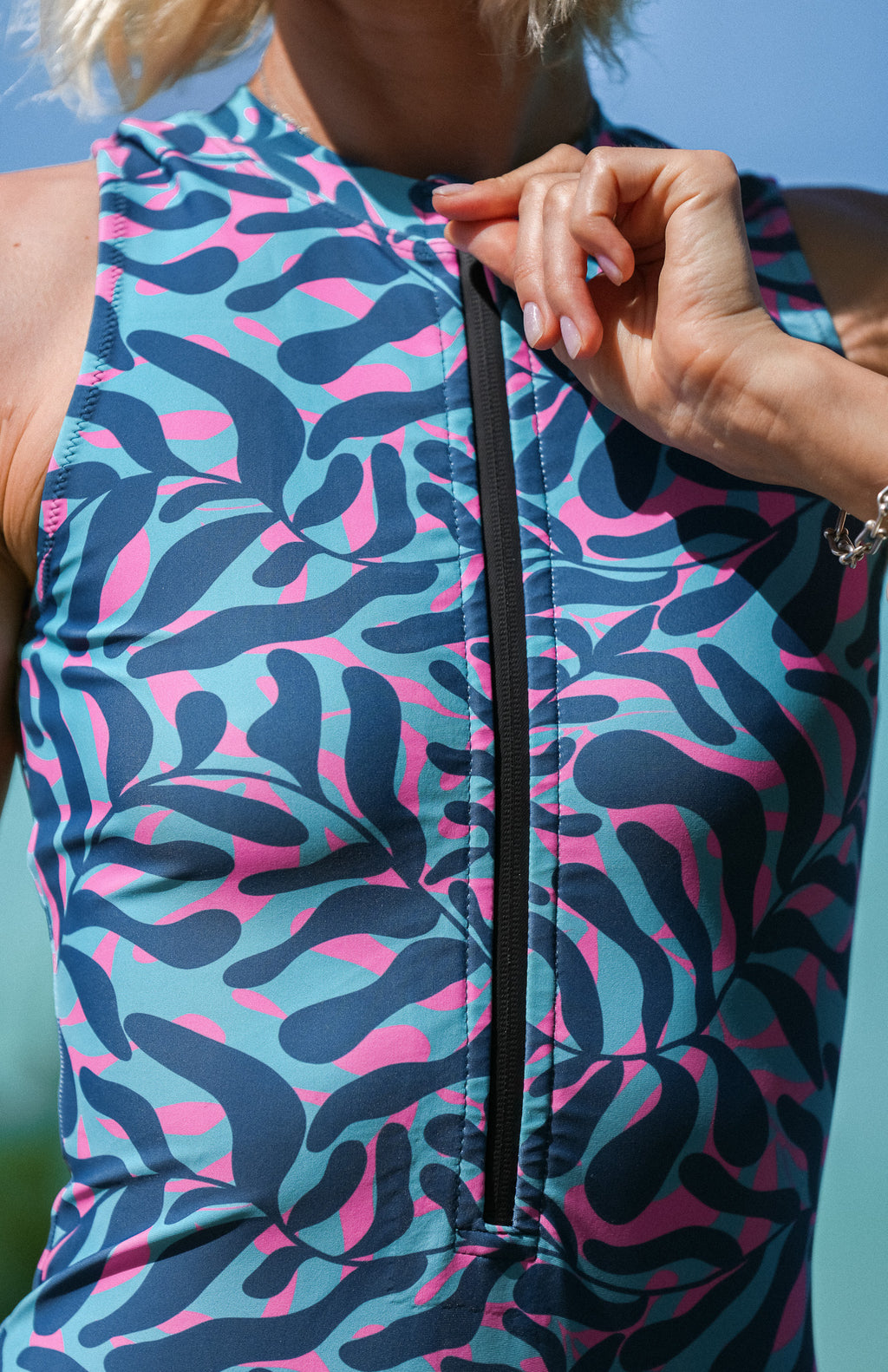sleeveless surf suit rash guard from lycra with front zipper for women with colourful blue, turquoise and pink print