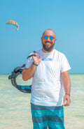 mens rash guard lycra with short sleeve for water sports or enjoying life at the beach with white base color with Bahari print on from and a coral head wind print on the back
